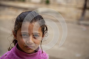 Portrait of a pretty Syrian Girl in a poor neighborhood