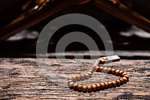 Tasbih or Islamic prayer beads on rustic wooden surface