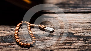 Tasbih or Islamic prayer beads on rustic wooden surface