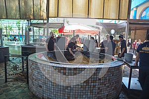 Tashkent, Uzbekistan - 5 May, 2023: Central Asia. Bwsh kazan. Cook stirs rice in a cauldron. Traditional cooking pilaf