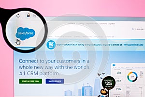 Tashkent, Uzbekistan, May 15, 2020: Photo of Salesforce website homepage on a monitor screen through a magnifying glass.