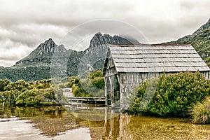 Tasmania`s Cradle Mountain with Dove Lake and historic boat shed