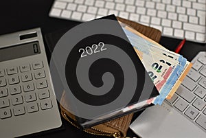 Tastatures, euro bills, wallet and zipbook calendar for 2022