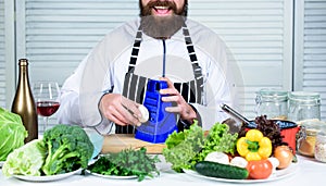 Taste it. Chef man in hat. Secret taste recipe. Vegetarian. Mature chef with beard. Bearded man cook in kitchen
