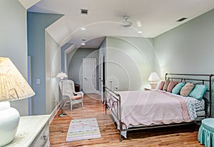 Tasteful attic bedroom with hard wood floors