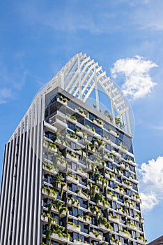 A tastefully contemporary green facade of a multi-storey building