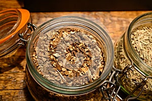 Tastes of gin, botanicals ingredients for gin distillery process, pot with dried orris root