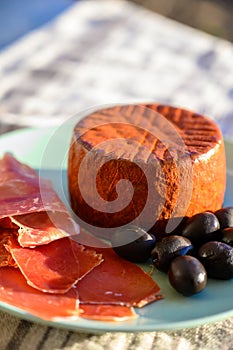 Tastes of Spain, jamon iberian, black olives and manchego cheese with red paprika