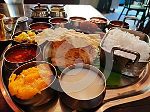 Tastey yummy south Indian lunch thali with variety of dishesh and sweet kesari curd rice parrota aplam papad lunch