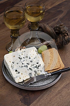 Tastig of French king of cheeses, sheep milk blue cheese roquefort from Southern France with sweet dessert white wine
