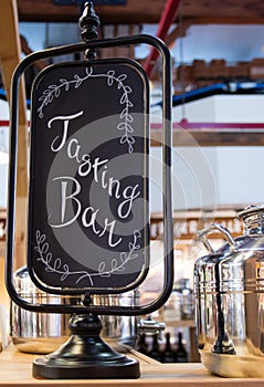 Tasting bar sign with shiny stainless steel pot