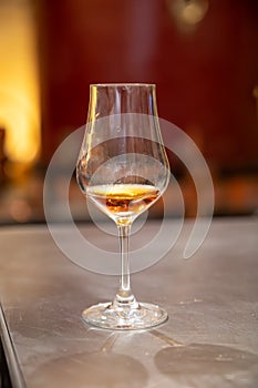 Tasting of cognac spirit aged in old French oak barrels in cellar in distillery in Cognac white wine region, Charente, Segonzac,