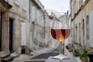 Tasting of cognac spirit aged in old French oak barrels in cellar in distillery in Cognac white wine region, Charente, Segonzac,