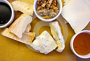 Tasting of different italian cheeses, parmesan Italian Parmigiano-Reggiano hard cheese, dolce and picante gorgonzola from Lombardy