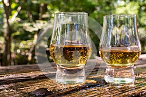 Tasting of different Scotch whiskies on outdoor terrace, dram of whiskey