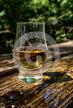 Tasting of different Scotch whiskies on outdoor terrace, dram of whiskey