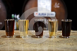 Tasting of different sweet wines from wooden barrels on old bodega in central part of Malaga, Andalusia, Spain