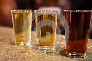 Tasting of different sweet wines from wooden barrels on old bodega in central part of Malaga, Andalusia, Spain