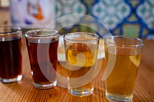 Tasting of different sweet wines from wooden barrels on old bodega in central part of Malaga, Andalusia, Spain