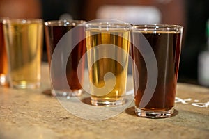 Tasting of different sweet wines from wooden barrels on old bodega in central part of Malaga, Andalusia, Spain