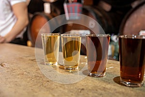 Tasting of different sweet wines from wooden barrels on old bodega in central part of Malaga, Andalusia, Spain