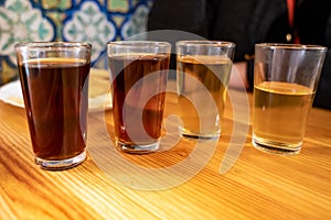 Tasting of different sweet wines from wooden barrels on old bodega in central part of Malaga, Andalusia, Spain