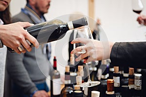 Tasting experience with a female sommelier serving a glass of Barolo red wine