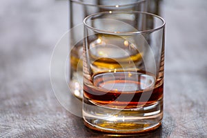 Tasting of flight of Scotch whisky from tumbler glasses in old Edinburgh pub,  Scotland, UK