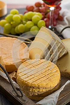 Tasting of oldest french AOC soft pudgent yellow cheese Livarot, Munster and semifirm Tomme french cheeses