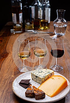 Tasting and pairing of different cheeses with strong alcoholic drinks, whisky, cognac or calvados