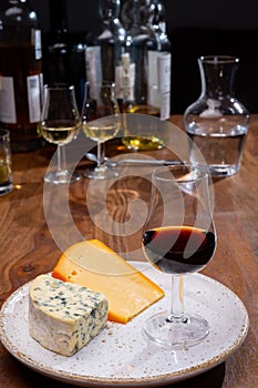 Tasting and pairing of different cheeses with strong alcoholic drinks, whisky, cognac or calvados