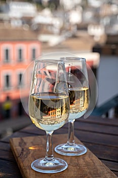 Tasting of Spanish sweet and dry fortified Vino de Jerez sherry wine with view on roofs and houses of old andalusian town photo