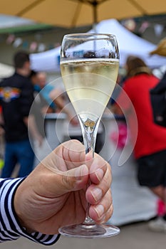 Tasting of sparkling white wine with bubbles champagne on summer festival route of champagne in Cote des Bar, Champagne region,