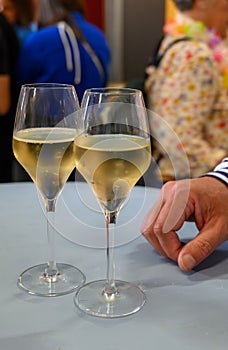 Tasting of sparkling white wine with bubbles champagne on summer festival route of champagne in Cote des Bar, Champagne region,