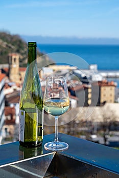 Tasting of txakoli or chacolÃ­ slightly sparkling very dry white wine produced in Spanish Basque Country