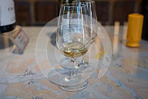 Tasting of white dry chablis wine in small winery in Chablis town, Burgundy, France