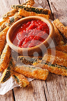 Tasty appetizer: Baked zucchini sticks breaded and spicy tomato