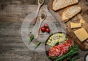 Tasty appetizers, avocado and cut tomatoes, topview, textspace