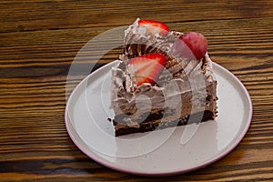 Tasty appetizing cake with strawberries cream and chocolate on white background