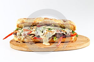 Tasty beef steak sandwich with onions, mushroom and melted provolone cheese photo