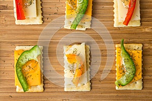 Tasty bite sized appetizers on saltine crackers