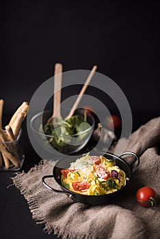 tasty boiled spaghetti pasta with basil leaves tomato sack with bread sticks veg salad. High quality photo