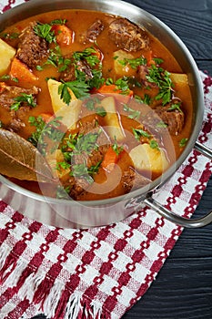 Tasty braised beef with potato and carrots photo