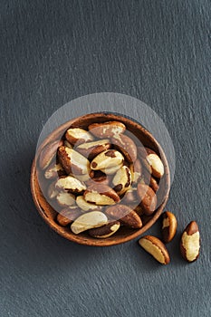 Tasty brasil nuts on slate background