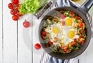 Tasty breakfast. Fried eggs with vegetables. Shakshuka.