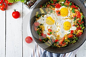 Tasty breakfast. Fried eggs with vegetables. Shakshuka.