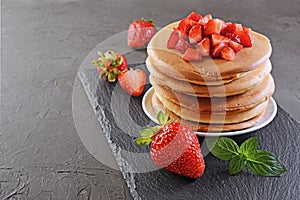 Tasty breakfast. Homemade pancakes with fresh strawberry and mint