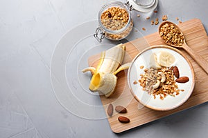 Tasty breakfast with yogurt, banana and granola