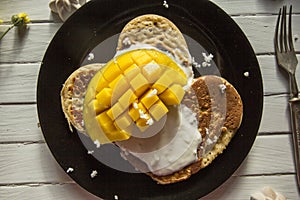 Tasty bright healthy breakfast-pancakes, yogurt and mango