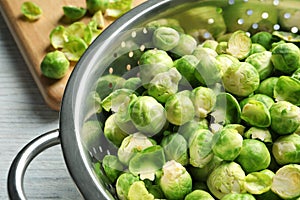 Tasty Brussels sprouts in colander on table